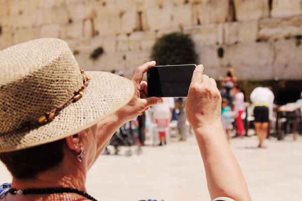 Elderly Woman Takes Picture At Western Wall
